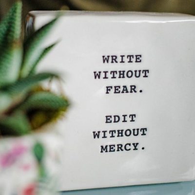 Rebuild your resume - a white box with writing on it next to a plant
